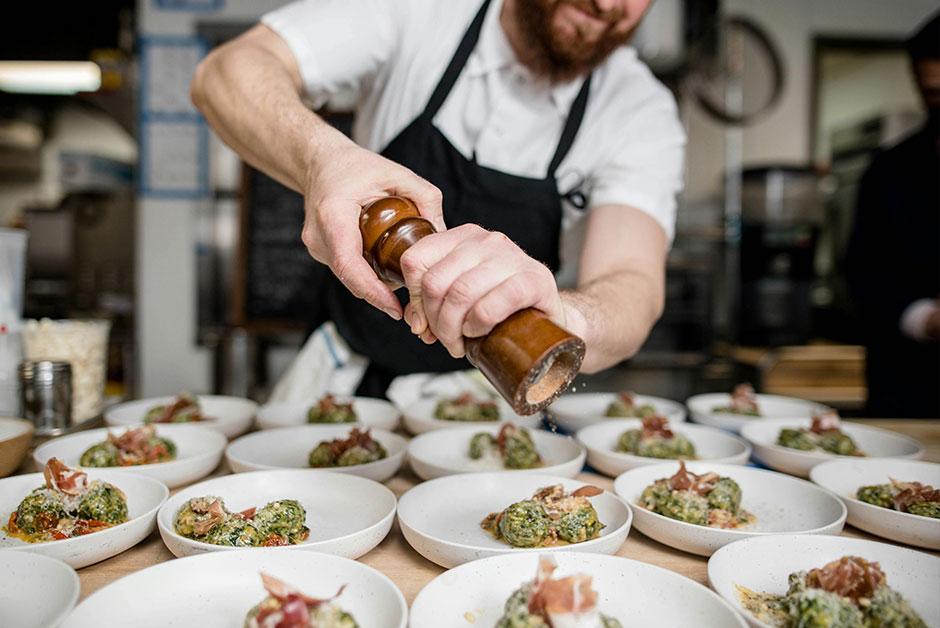 A Chef Seasoning Dishes