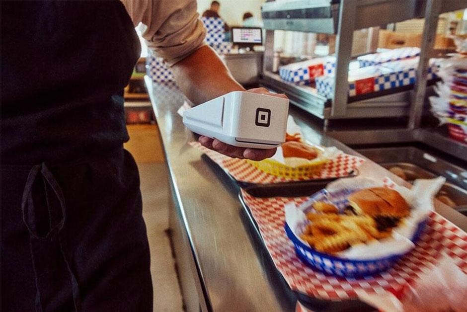 Waiter using a Square POS system.